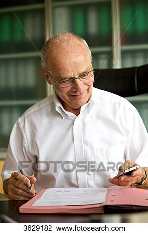 Senior man working in home office View Large Photo Image Stock Image - Senior man working in home office . Fotosearch