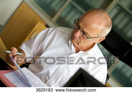 Senior man working in home office View Large Photo Image Stock Image - Senior man working in home office . Fotosearch