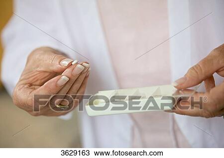 Senior woman taking pill, close-up View Large Photo Image Stock Image - Senior woman taking pill, close-up . Fotosearch