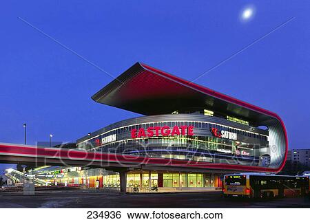 Shopping mall lit up at dusk, Eastgate Station, Marzahn-Hellersdorf, Berlin, Germany View Large Photo Image Stock Photograph - Shopping mall lit up at dusk, Eastgate Station, Marzahn-Hellersdorf, Berlin, Germany . Fotosearch