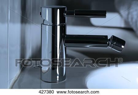 Stock Image - Side profile of faucet at washbasin . Fotosearch