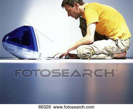 Side profile of man working on computer View Large Photo Image Stock Photo - Side profile of man working on computer . Fotosearch