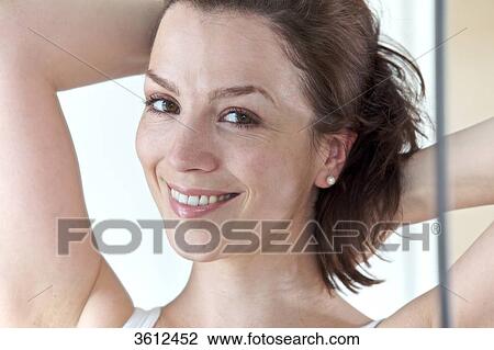 Stock Image - Smiling brunette woman, portrait . Fotosearch