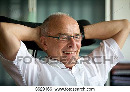 Smiling senior man in home office View Large Photo Image Stock Photograph - Smiling senior man in home office . Fotosearch