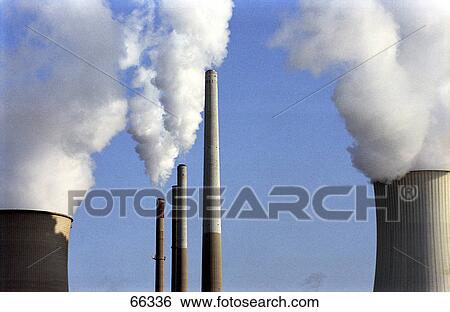 Stock Photograph - Smoke emitting from chimneys . Fotosearch