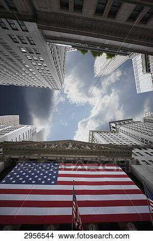 Picture - Stars and Stripes in front of the New York Stock Exchange, USA, worm's-eye view . Fotosearch