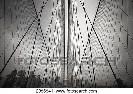 Stock Image - Steel ropes of the Brooklyn Bridge, New York City, USA, wide-angle . Fotosearch