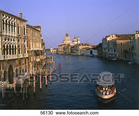 Stock Image - Tourists on boat in canal, Grand Canal, Venice, Italy . Fotosearch