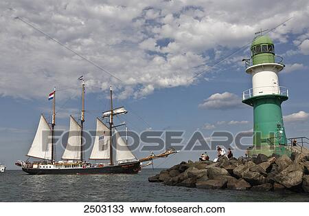 Tourists standing near lighthouse at coast, Warnemunde, Mecklenburg-Vorpommern, Berlin, Germany View Large Photo Image Stock Image - Tourists standing near lighthouse at coast, Warnemunde, Mecklenburg-Vorpommern, Berlin, Germany . Fotosearch