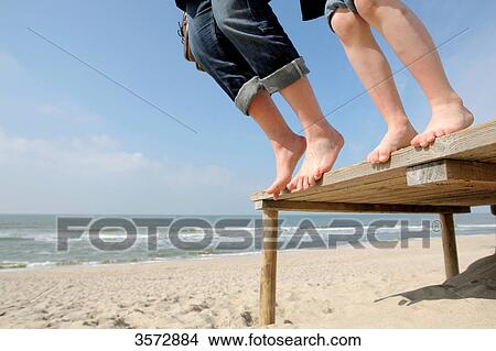 Two tourists jumping from boardwalk, Hoernum, Sylt, Schleswig-Holstein, Germany, Europe View Large Photo Image Picture - Two tourists jumping from boardwalk, Hoernum, Sylt, Schleswig-Holstein, Germany, Europe . Fotosearch