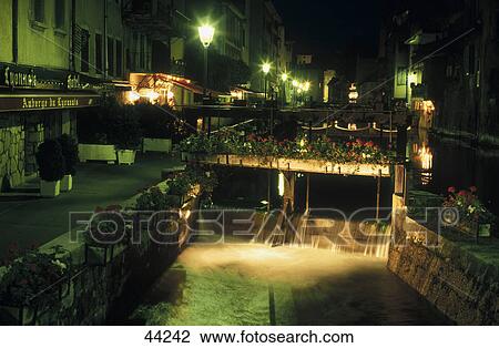 Stock Image - Water weir on canal at night, Annecy, Haute-Savoie, France . Fotosearch
