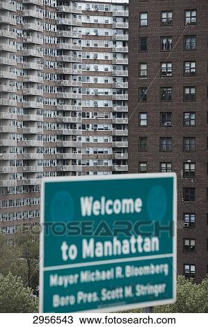 Stock Image - Welcome sign in front of shabby apartment buildings, New York City, USA . Fotosearch