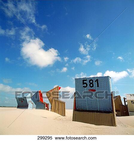 Stock Photography - Wicker beach chairs on beach . Fotosearch