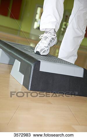 Woman exercising on stepper, close-up View Large Photo Image Stock Image - Woman exercising on stepper, close-up . Fotosearch