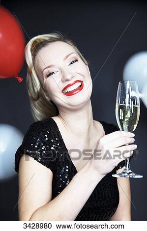 Stock Image - Woman holding champagne glass . Fotosearch