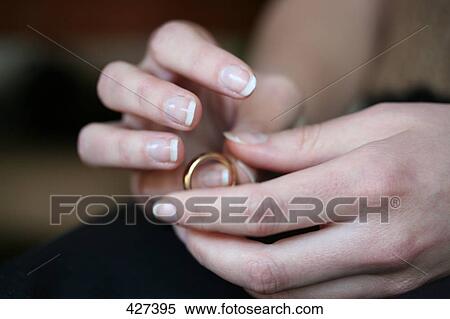 Stock Photography - Woman holding ring, close-up . Fotosearch