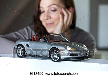 Woman looking at toy car View Large Photo Image Stock Image - Woman looking at toy car . Fotosearch