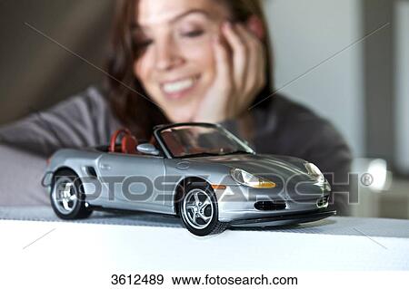 Woman looking at toy car View Large Photo Image Stock Photo - Woman looking at toy car . Fotosearch