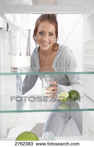 Stock Image - woman looking into an empty cooler . Fotosearch