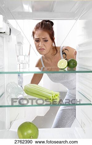 Stock Image - woman looking into an empty cooler . Fotosearch