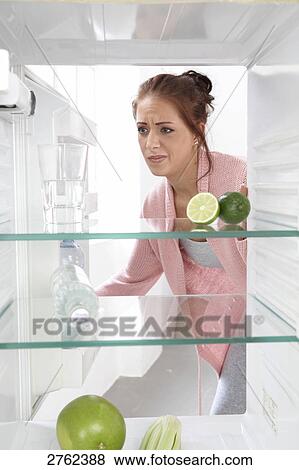 woman looking into an empty cooler View Large Photo Image Stock Photo - woman looking into an empty cooler . Fotosearch