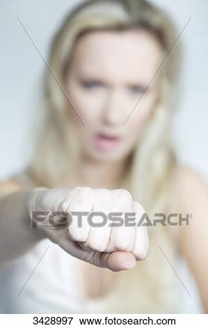 Stock Photo - Woman punching at camera . Fotosearch