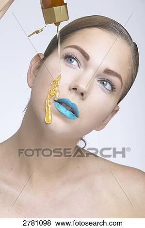 Stock Photo - woman putting on some make-up, portrait . Fotosearch