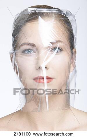 Stock Image - woman wrapped in foil, portrait . Fotosearch