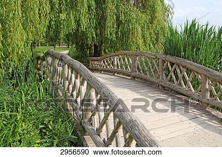 Wooden bridge in the castle garden of Schwerin, Germany View Large Photo Image Stock Image - Wooden bridge in the castle garden of Schwerin, Germany . Fotosearch