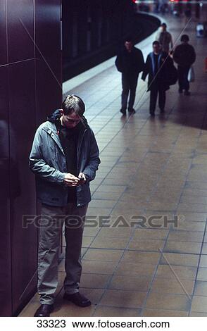 Stock Image - Young man using a mobile phone . Fotosearch