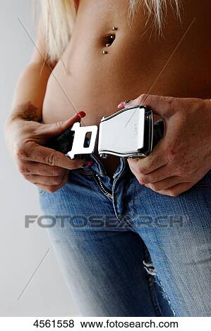 Young woman closing belt, mid section View Large Photo Image Stock Photo - Young woman closing belt, mid section . Fotosearch