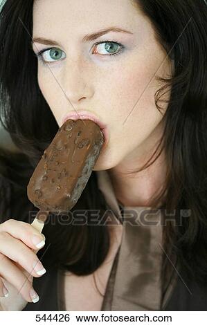 Young woman eating ice cream View Large Photo Image Stock Photograph - Young woman eating ice cream . Fotosearch