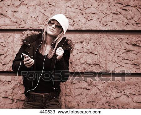 Young woman listening to mp3 player View Large Photo Image Stock Image - Young woman listening to mp3 player . Fotosearch
