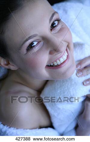 Stock Photo - Young woman smiling at camera . Fotosearch