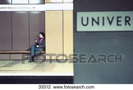 Stock Image - Young woman using a mobile phone . Fotosearch