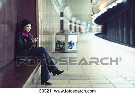 Young woman using a mobile phone View Large Photo Image Stock Image - Young woman using a mobile phone . Fotosearch