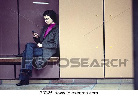 Stock Photography - Young woman using mobile phone . Fotosearch
