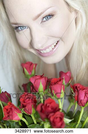 Young woman with a bouquet of roses, portrait View Large Photo Image Stock Image - Young woman with a bouquet of roses, portrait . Fotosearch