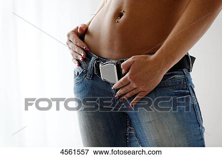Stock Photo - Young woman with hand on hip, mid section . Fotosearch