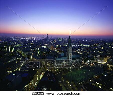 Stock Image - Aerial view of city lit up at night, Hamburg, Germany . Fotosearch