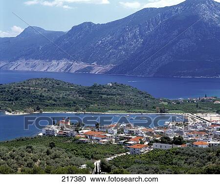 Stock Image - Aerial view of town with mountain in background, Epidaurus, Greece . Fotosearch