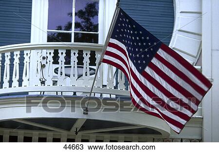 Stock Image - American flag hanging on balcony, New Orleans, Louisiana, USA . Fotosearch