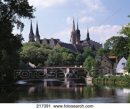 Arch bridge across river with cathedral in background View Large Photo Image Stock Image - Arch bridge across river with cathedral in background . Fotosearch