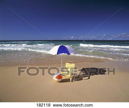 Beach ball and chair with umbrella on beach, Puerto Del Carmen, Lanzarote, Canary Islands, Spain View Large Photo Image Stock Photo - Beach ball and chair with umbrella on beach, Puerto Del Carmen, Lanzarote, Canary Islands, Spain . Fotosearch