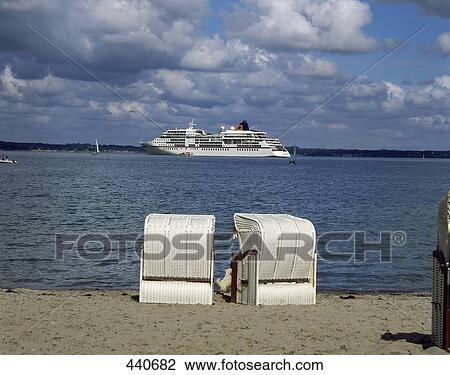 Stock Image - Beach chairs on beach, Schleswig-Holstein, Germany . Fotosearch