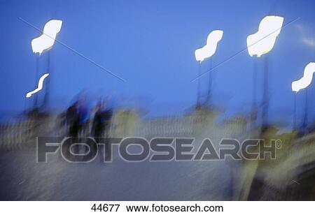 Stock Photo - Blurred view of people walking on bridge . Fotosearch