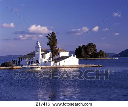 Stock Photography - Boat moored at church on island . Fotosearch