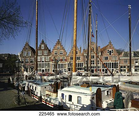Stock Photography - Boats moored at harbor, Ijssel River, Netherlands . Fotosearch