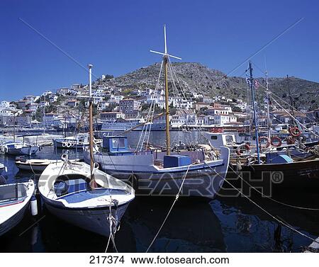 Picture - Boats moored at harbor . Fotosearch