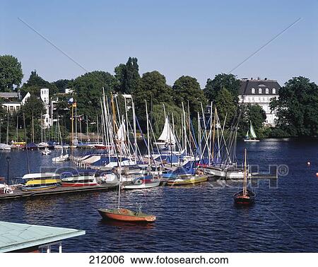 Stock Photograph - Boats moored at harbor, River Alster, Hamburg, Germany . Fotosearch